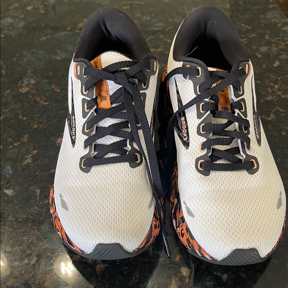 Brooks White Running Shoes with Black Laces and Orange Accents